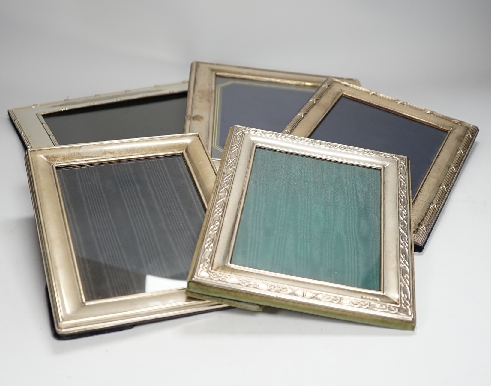 Four assorted modern silver mounted photograph frames, largest 25.9cm and one silver plated photograph frame.